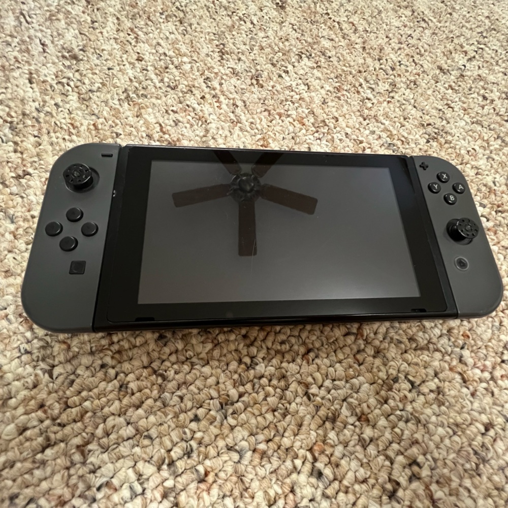 Gray Nintendo Switch, used and scratched